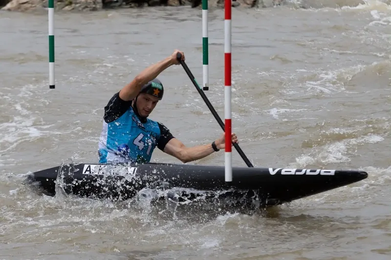 Kayaker paddling through water